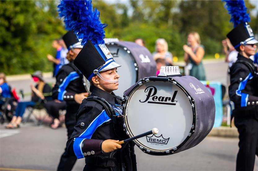 Band member plays drums in parade